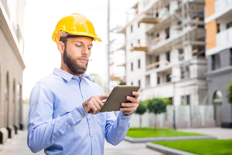 Construction worker using a tablet to access SecureCore from the cloud